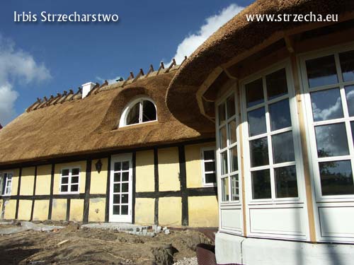 A thatched roof with a finished straw ridge